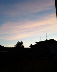 Low angle view of silhouette building against sky