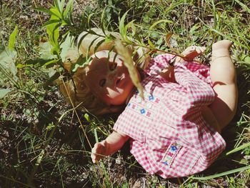 High angle view of girl lying on field