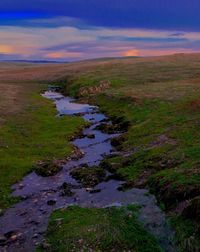 Scenic view of landscape against cloudy sky