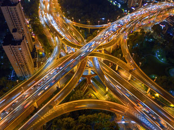 Aerial view of light trails on elevated road in city at night