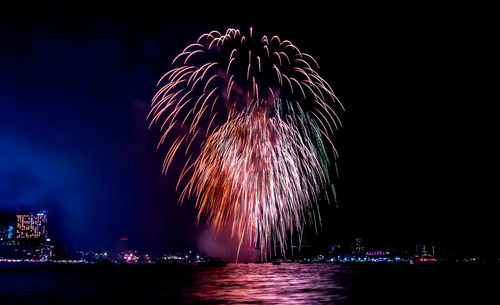 Firework display over city at night