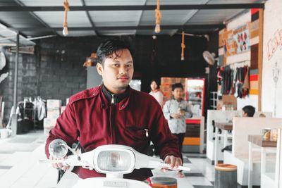 Portrait of a young man standing on table