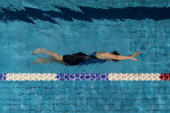 Directly above shot of woman swimming in pool