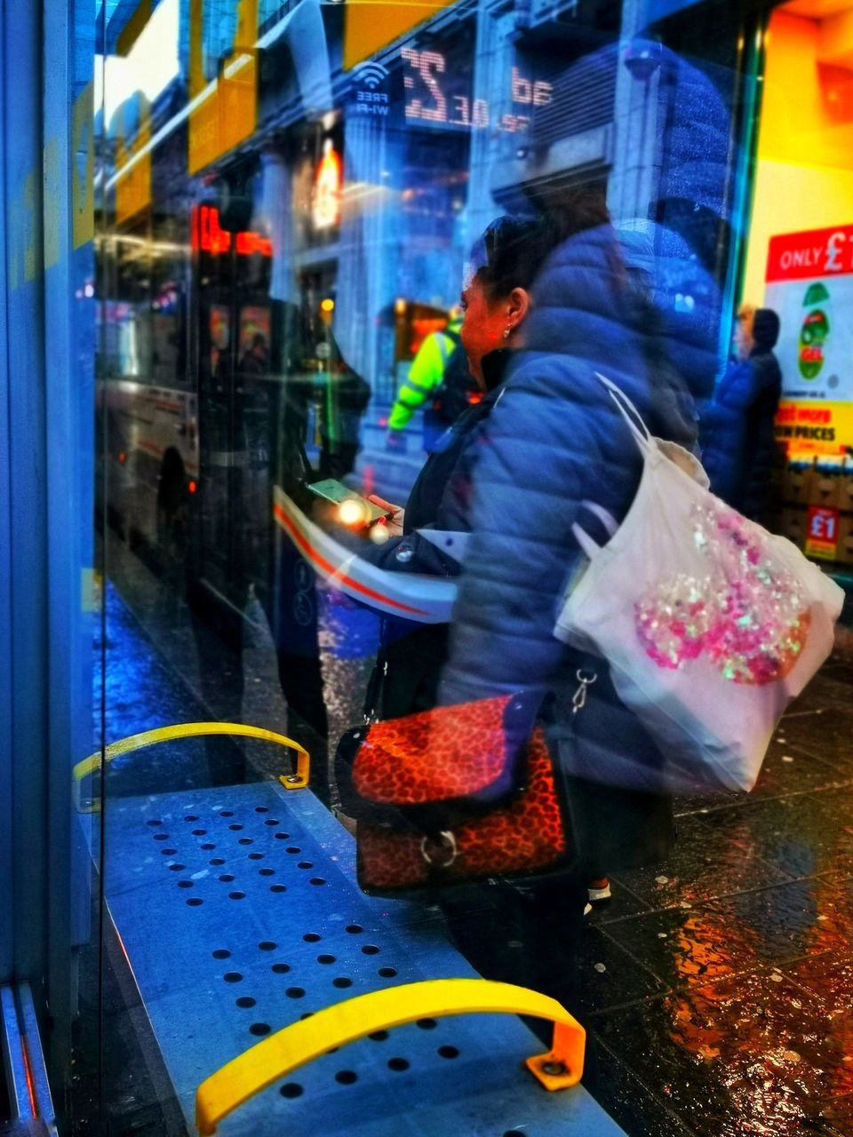 REAR VIEW OF MAN WORKING IN CITY AT NIGHT