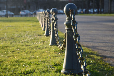 Close-up of chain hanging on swing in park