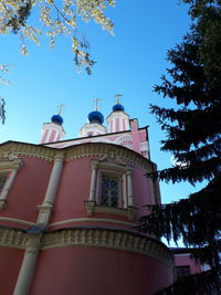 Low angle view of building and trees against sky