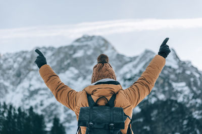 Low angle view of man standing against sky