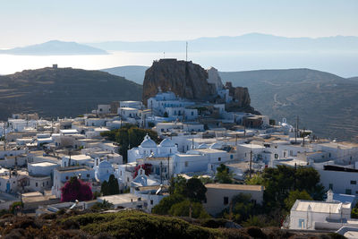 High angle view of townscape by sea against sky