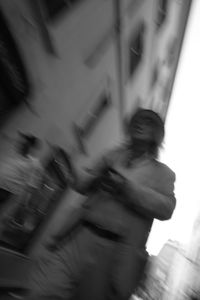 Blurred motion of people walking in city