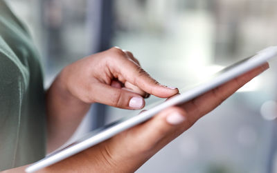 Midsection of man using mobile phone