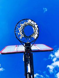 Low angle view of basketball hoop against blue sky