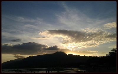Scenic view of mountains against sky at sunset