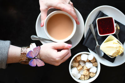 High angle view of hand holding coffee