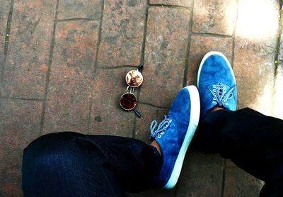 Low section of man standing on tiled floor
