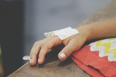 Cropped hand wearing iv drip in hospital