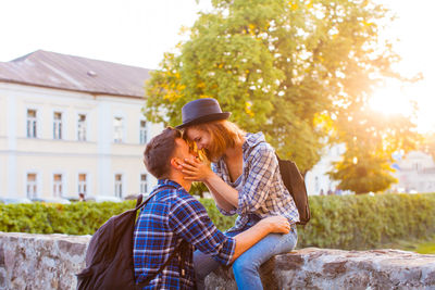 Rear view of couple kissing outdoors