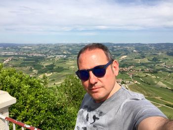 Portrait of man standing against landscape