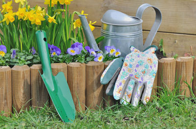 Flowers in pot by plants on field