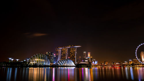 Illuminated city at waterfront