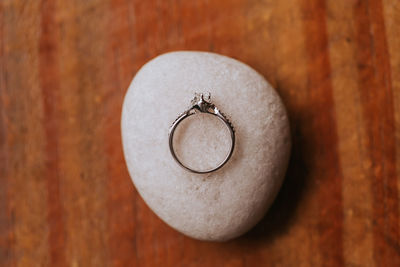 Directly above shot of engagement ring on stone