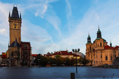 View from below of old town city hall and church from old town square in prague