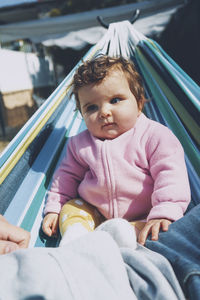 Portrait of cute baby sitting outdoors