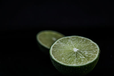 Close-up of lemon slice against black background