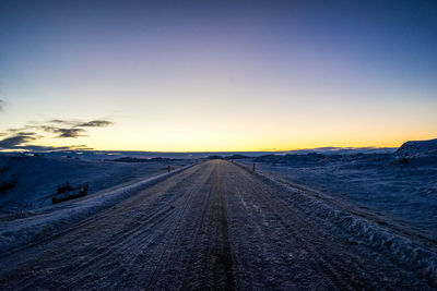 Scenic view of landscape against clear sky during winter