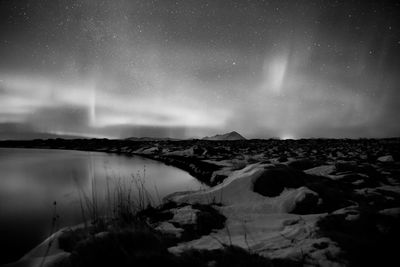 Scenic view of snow against sky at night