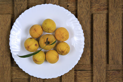 High angle view of fruits in plate on table