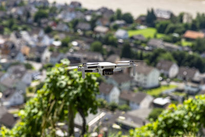 The drone hovers over the grape hills and countryside, the plastic propellers are on.