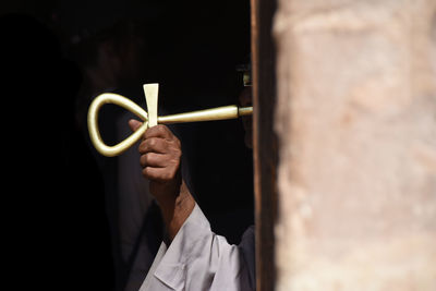Close-up of man holding golden key