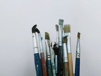 Directly above shot of paintbrushes on gray background