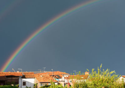 Rainbow over field against sky
