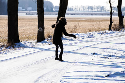 Full length of man on snow field against sky