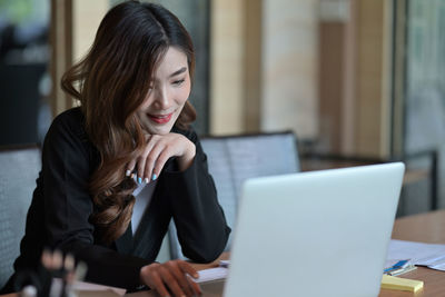 Businesswoman using laptop in office