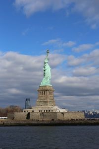 Statue of liberty against cloudy sky