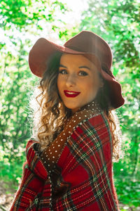 Portrait of beautiful woman standing at forest