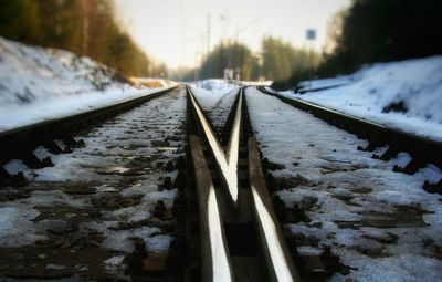 Railroad tracks in snow covered landscape