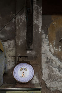 Close-up of old clock on wall