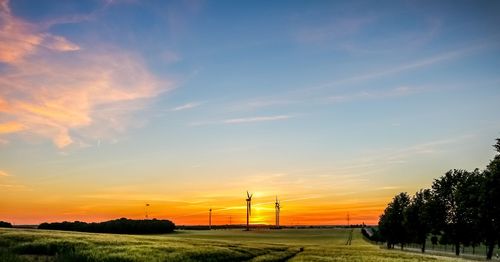 Scenic view of field against sky during sunset