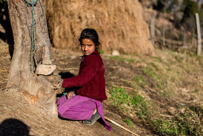 Side view portrait of a smiling young woman on land