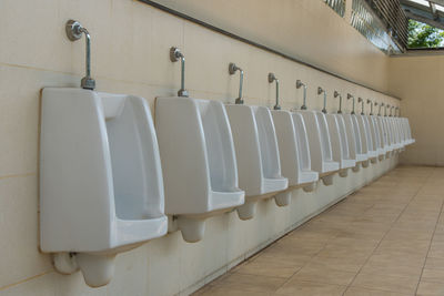 Close-up of urinal in public restroom