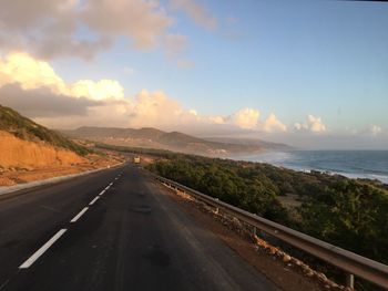 Road by sea against sky