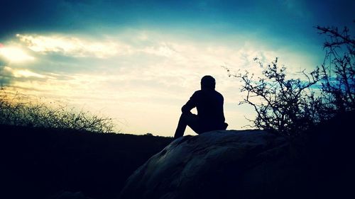 Silhouette of man against cloudy sky