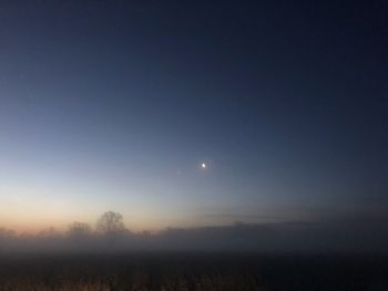 Scenic view of field against sky at night