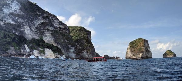 Panoramic view of sea and rocks against sky