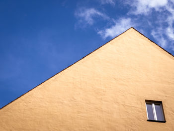 Low angle view of building against blue sky