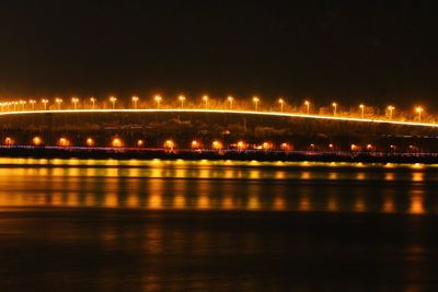 Illuminated suspension bridge at night