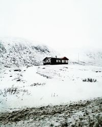 Text on snow covered land against clear sky